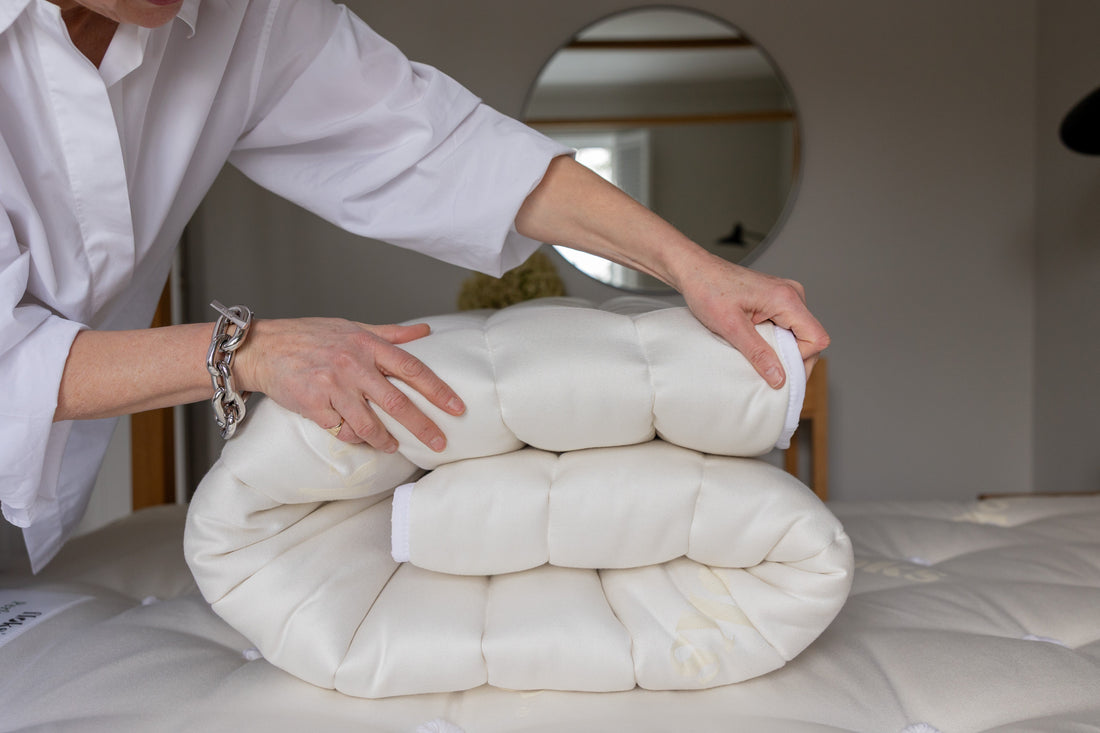 Floks luxury wool mattress topper folded on a bed