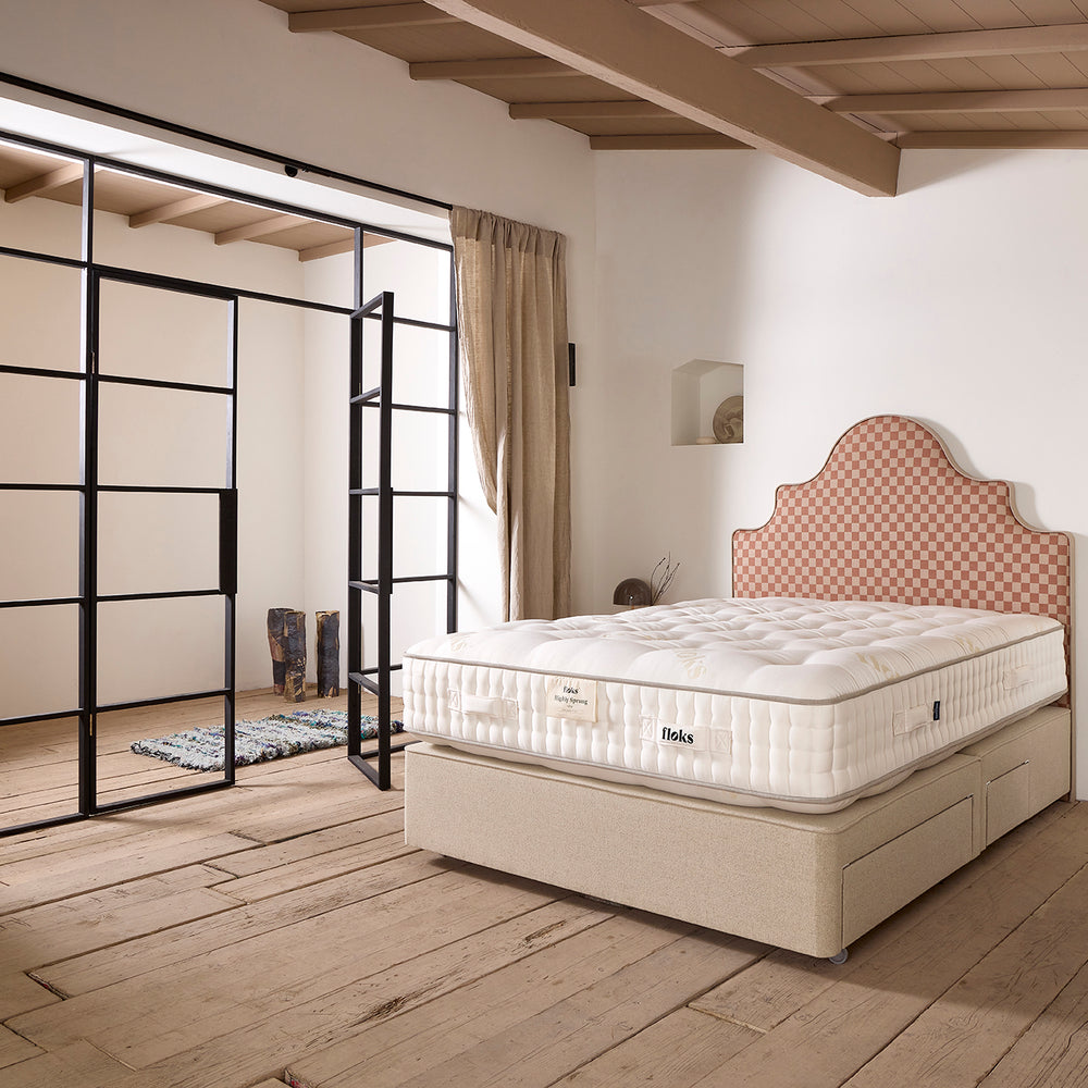 Beall bed shown from the side.  A deep divan sprung base with continental storage drawers and a luxurious British wool natural fibre mattress, designed to help you to sleep better.
