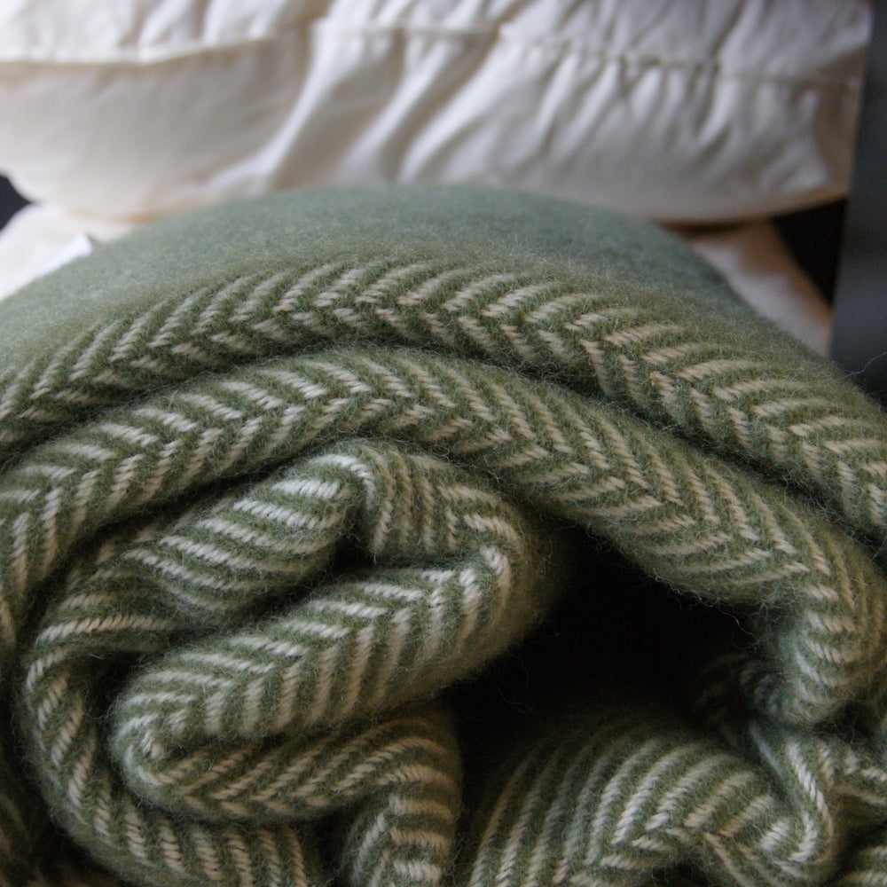 Rolled up Floks wool throw in green