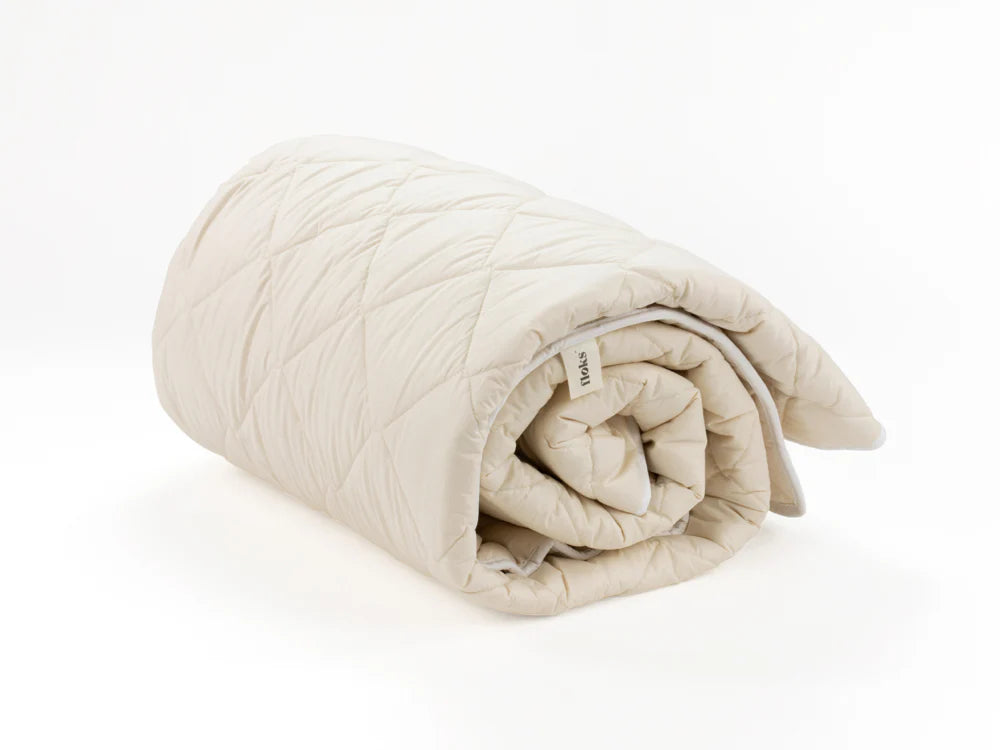 Floks luxury wool mattress protector rolled up