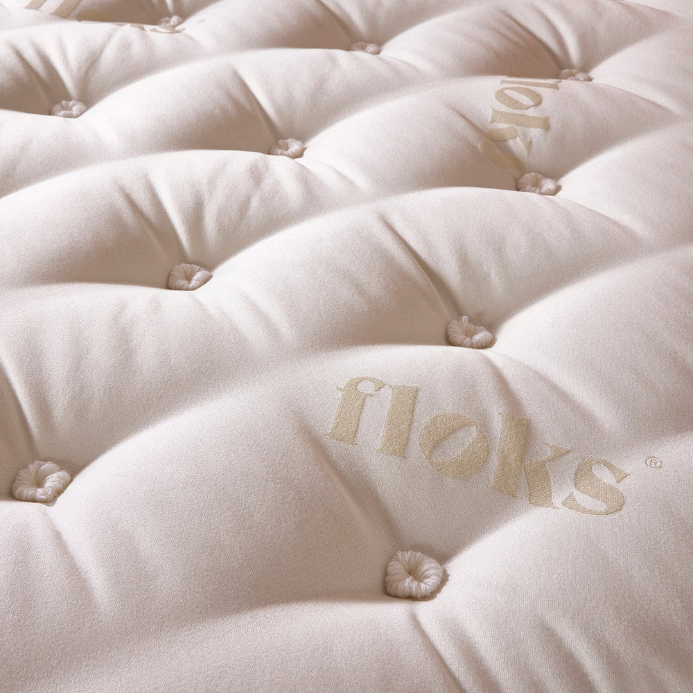 Close up detail of the top of the Floks Away 3250 Mattress made from UK-certified wool and pocket springs, offering luxury comfort and support.