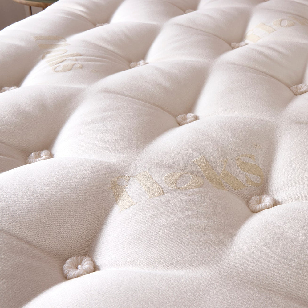 Perfectly Floks 5750 Mattress made from UK-certified wool and pocket springs, offering a cooling, supportive, and breathable sleep solution designed to transform the way you rest. Close up image of the top of the mattress.