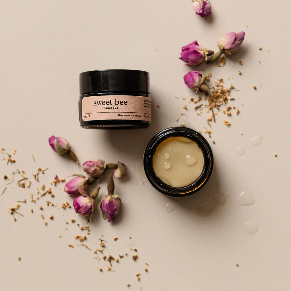 Sweet Bee Organics open jar and scattered flowers