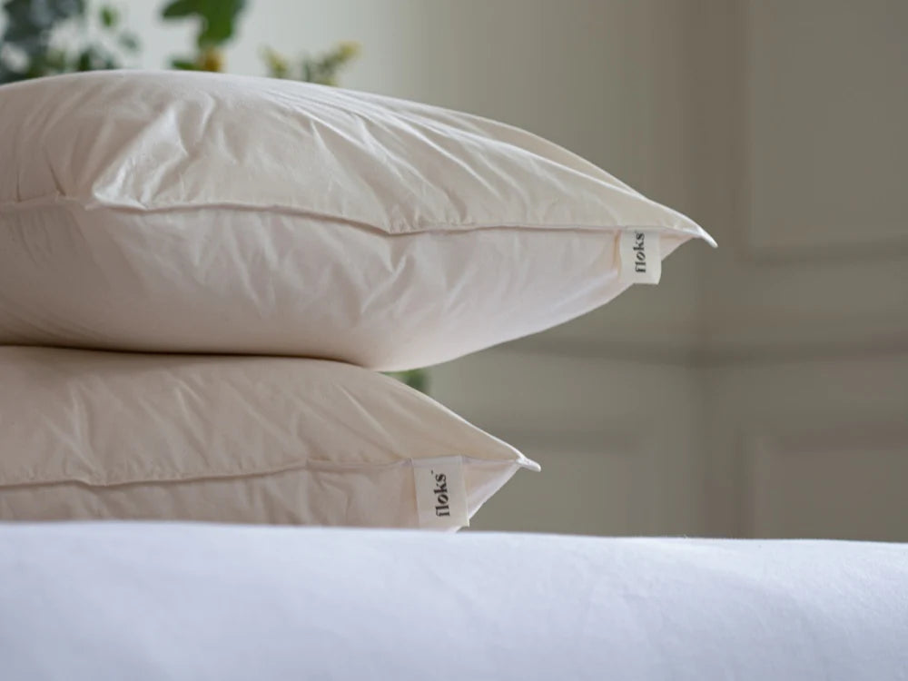 Floks Pair of Wool Pillows stacked on a bed